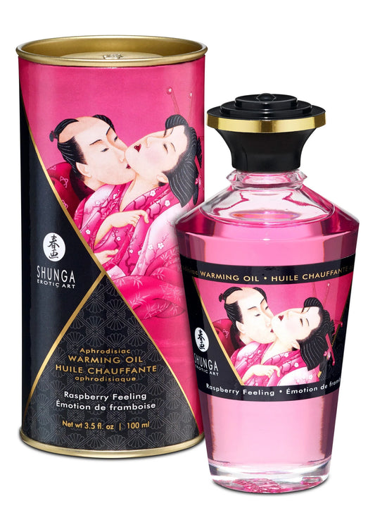 Shunga verwarmende olie fles met roze vloeistof en zwarte dop; framboos 100 ml