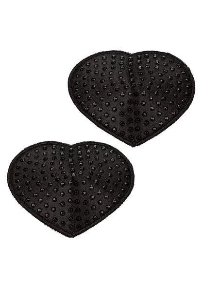 Twee zwarte hartvormige pasties met nopjes aan de achterkant