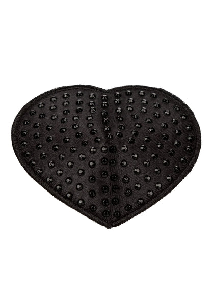 Hartvormige zwarte pasty met kleine noppen, close-up op het hartpatroon