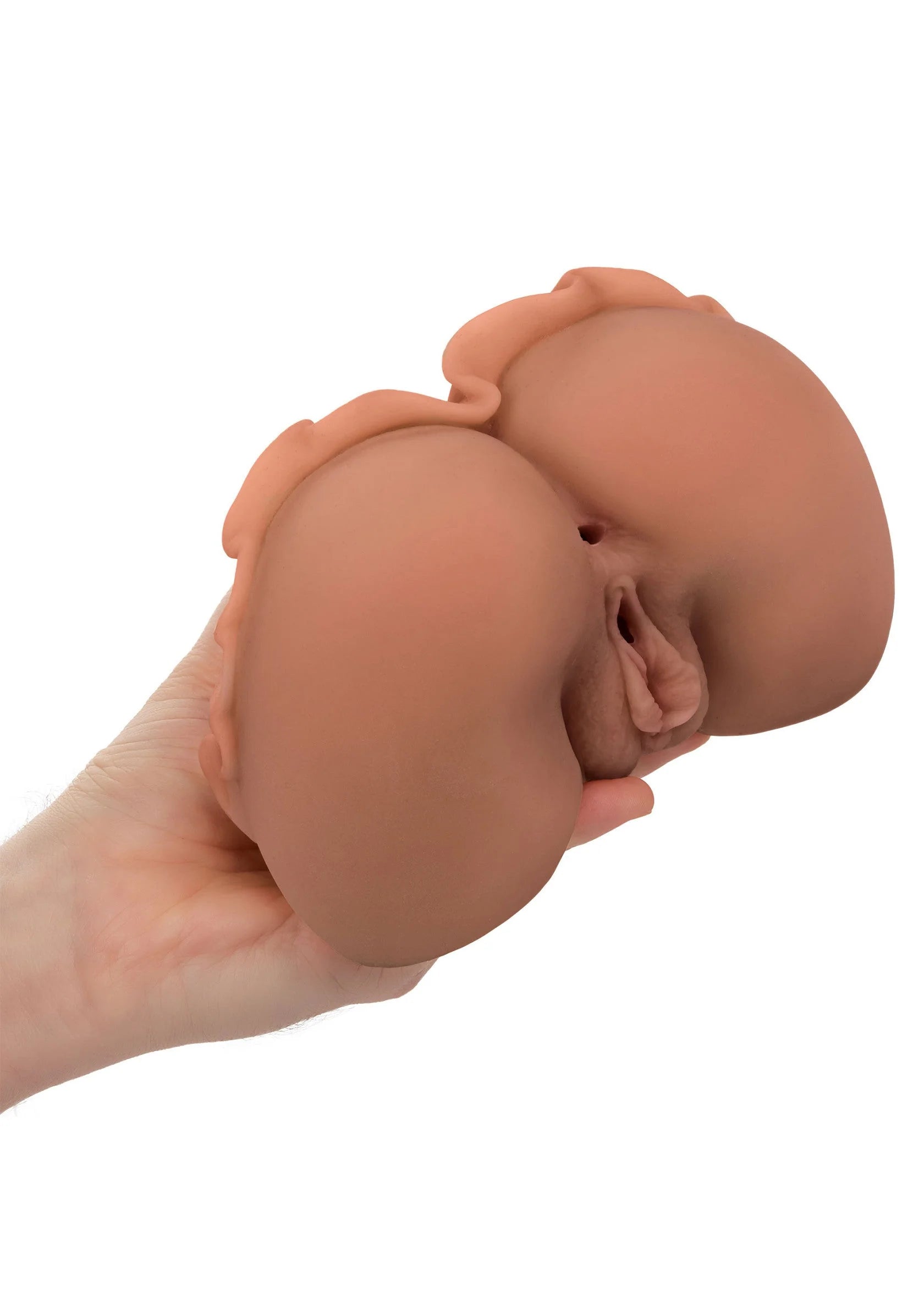 Huidkleurige sextoy vastgehouden in de hand met openingen zichtbaar