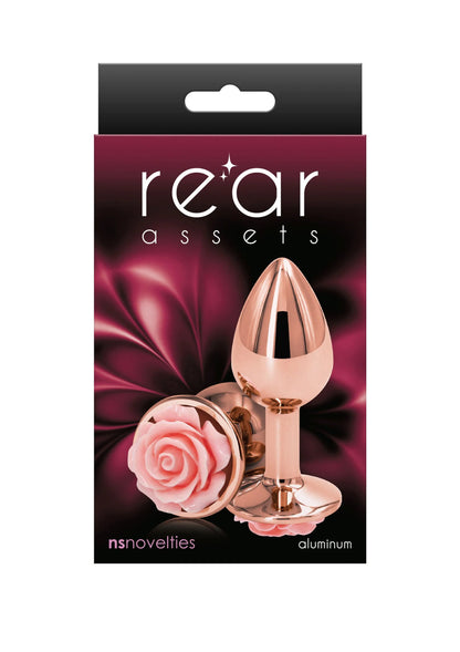 Kleine rozenbuttplug van NS Novelties in verpakking, rose-goudkleurige plug met roze roosbloem