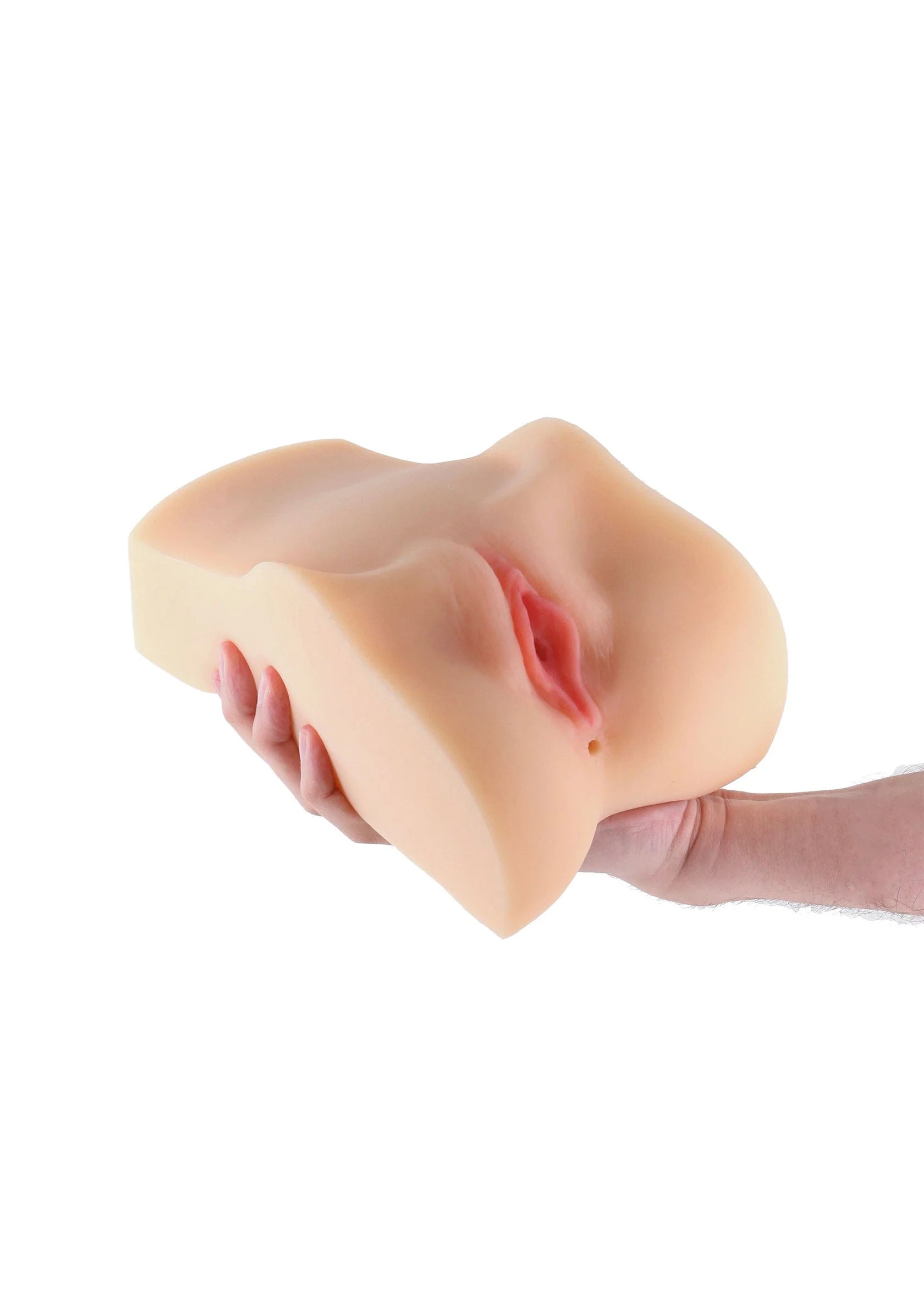 Fleshtone masturbatiehulpmiddel in hand, opening en neerwaartse vorm