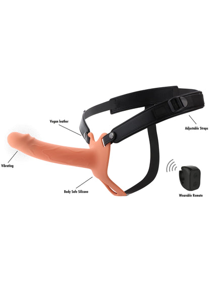Huidkleurige holle strapon in zwarte harness met trillingslabels