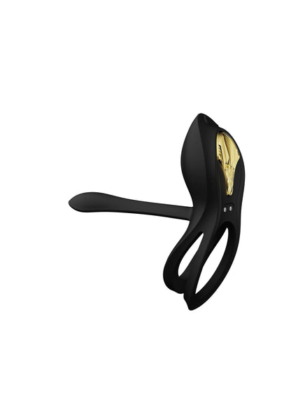 Zwarte cockring-vibrator met lange arm en ovale kop, gouden inzet zichtbaar.