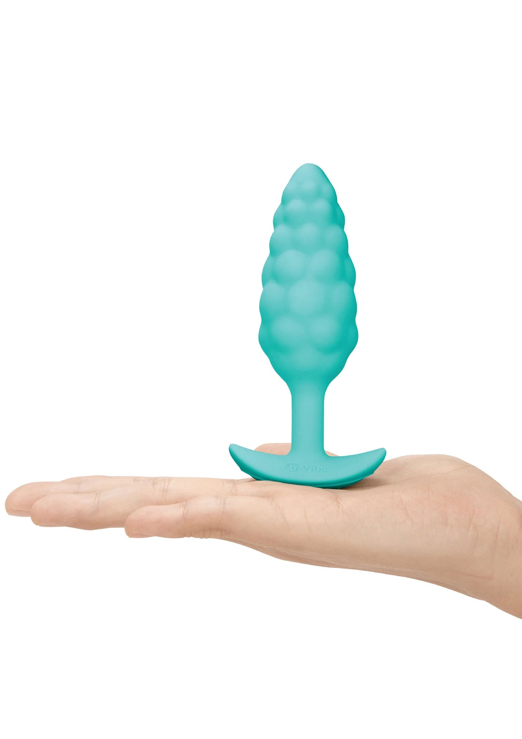 Turquoise anale plug met bultenstructuur en brede voet, staand op hand