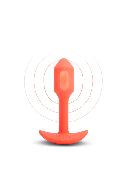 Oranje vibrerende anale plug op witte achtergrond, met ronde basis en glazen touchpunt.