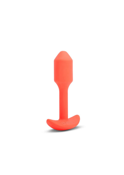 Oranje trilling snug plug van B-Vibe, rechtop met platte onderkant