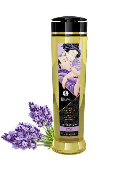 Shunga massageolie in gele fles met zwarte dop en gouden band, met paarse bloesems