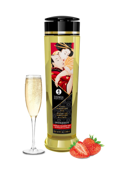 Massageolie-fles Shunga met zwarte dop en rode etiket, met glas en aardbei.