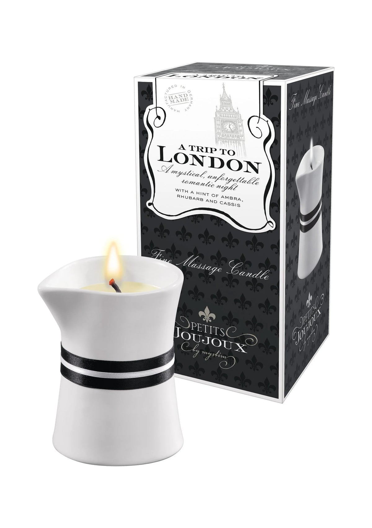 Massagekaars met vlam in witte houder naast zwarte London-cadeaudoos