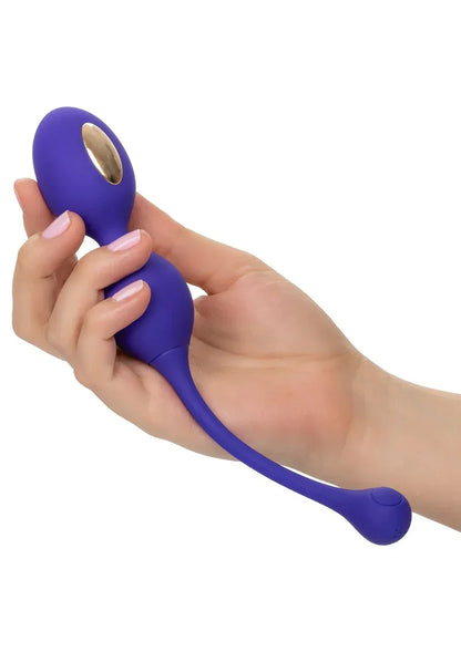 Donkerblauwe dual-kegel stimulator en afstandsbediening vastgehouden in hand