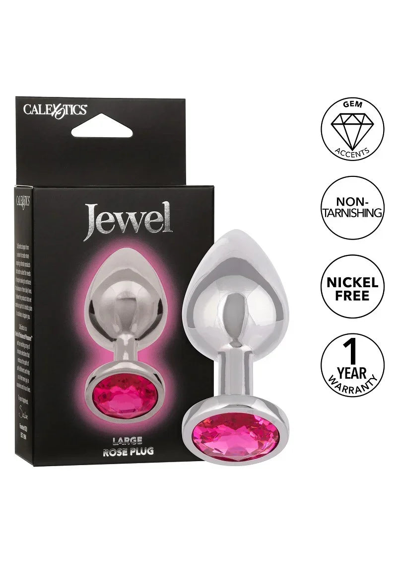 Doos en metalen anale plug met roze edelsteen en druppelvormige flens.
