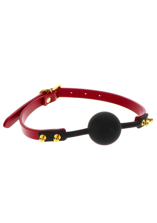 Zwarte siliconen ball-gag met rode band en gouden klinknagels, Taboom
